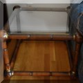 F21. Pair of mid century wood and glass side tables with brass decorations. 18"h x 25"w x 25"d 